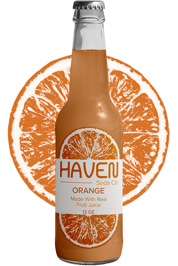 Haven orange soda bottle with orange behind the bottle.